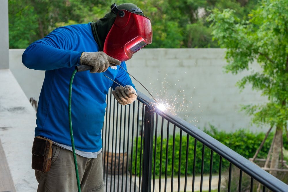 [Image: Welding-wearing-helmet-working-on-fence-...rstock.jpg]