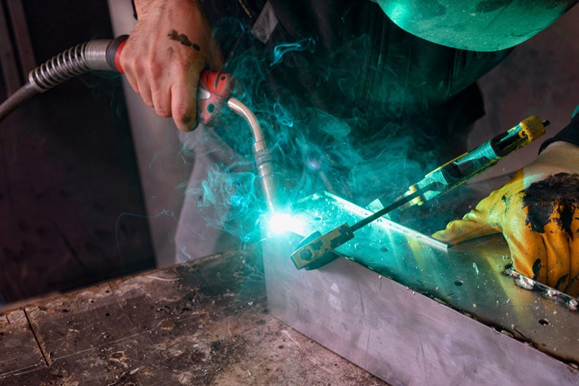 man welding aluminum with MIG