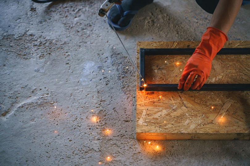 man welding metal for DIY project