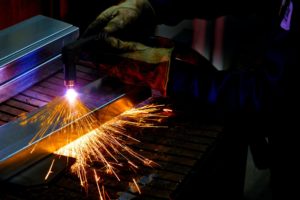 person using plasma cutter