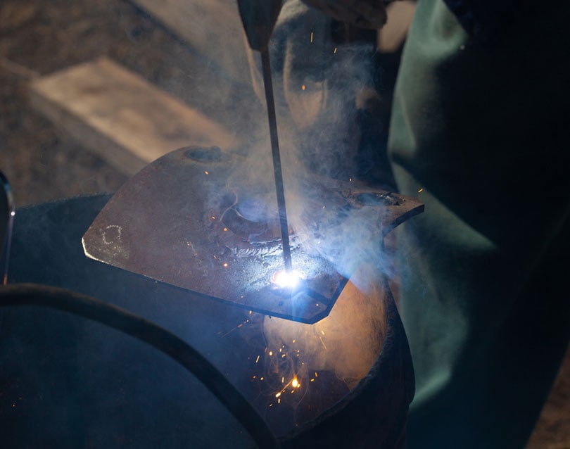 worker welding cast iron
