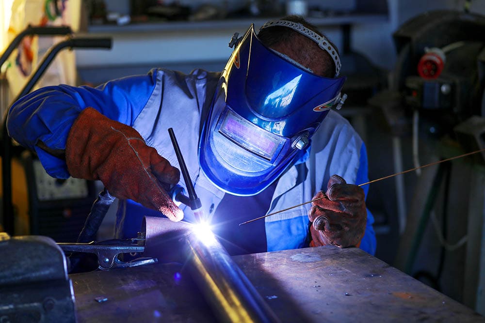 MIG welder working in a workshop